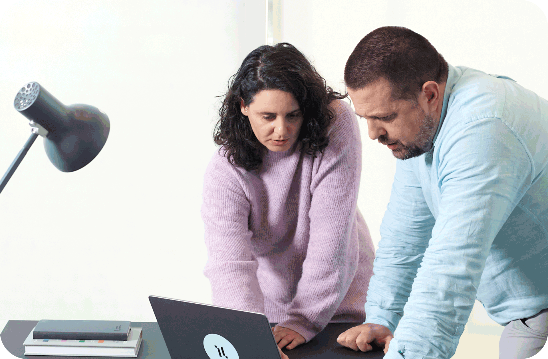 Two people talking over a computer