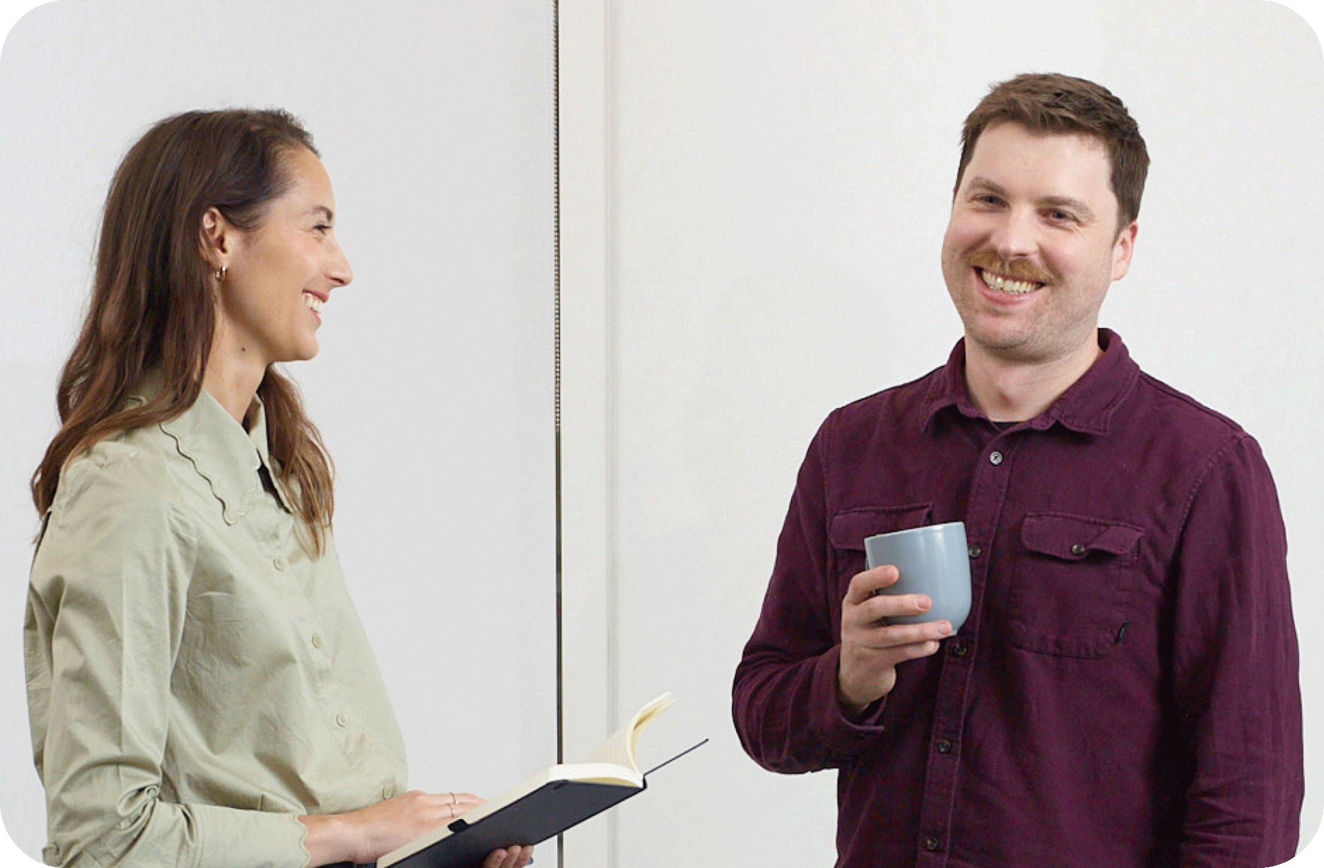 Two people going through a notebook