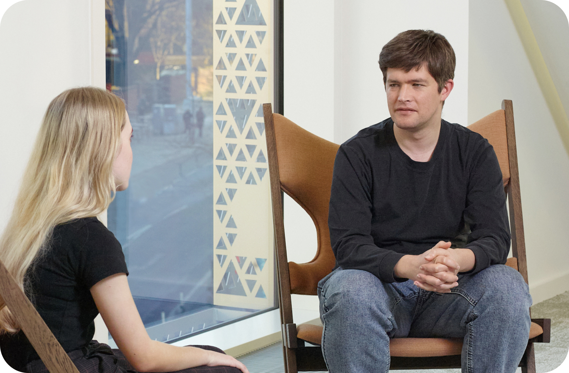 Two people sitting and talking