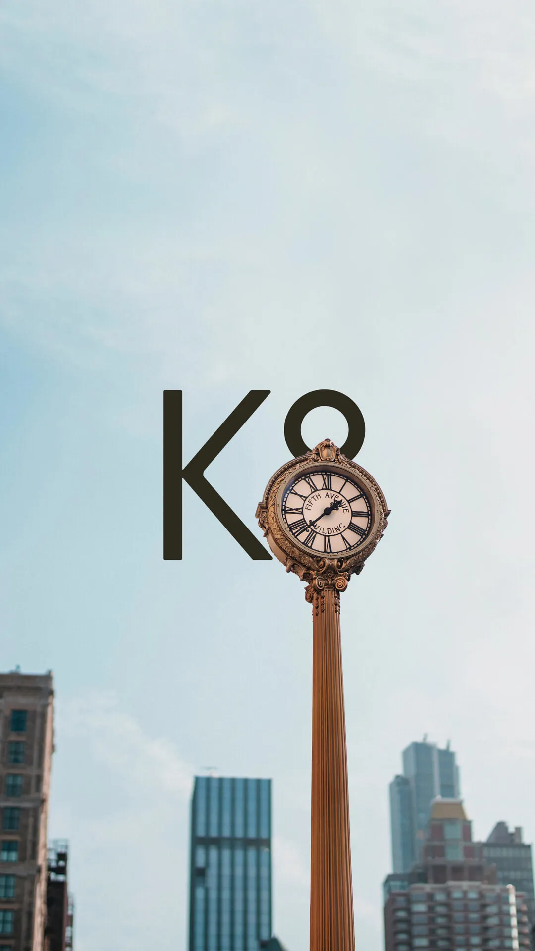 K8 logo in urban environment with a round clock covering half of the 8