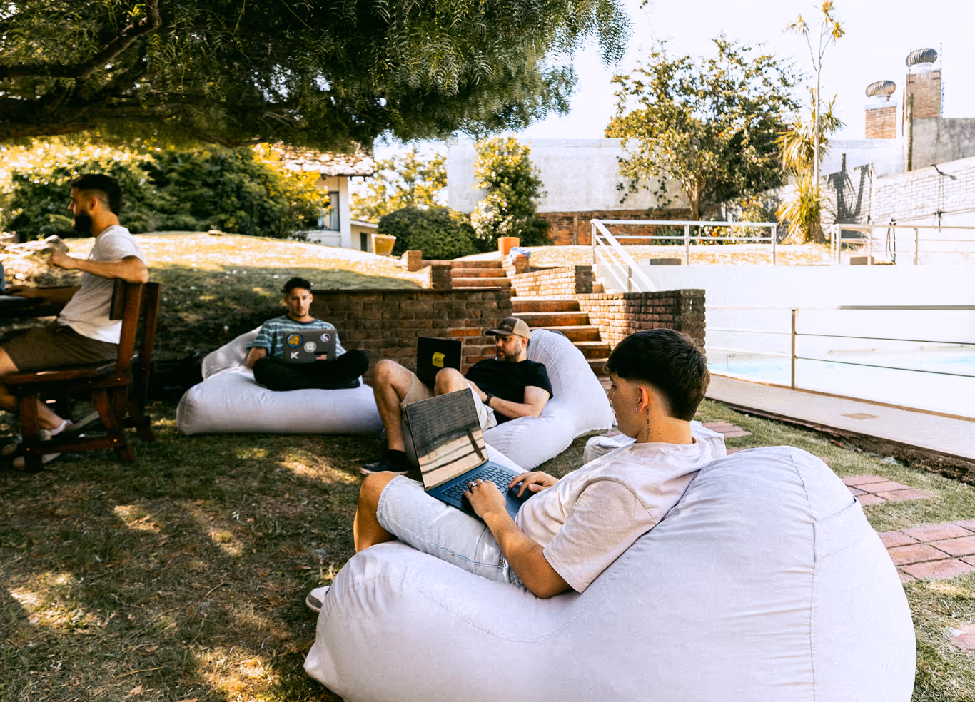 Our software development team enjoys a flexible work environment, collaborating on laptops in a relaxed outdoor space at our Montevideo office.