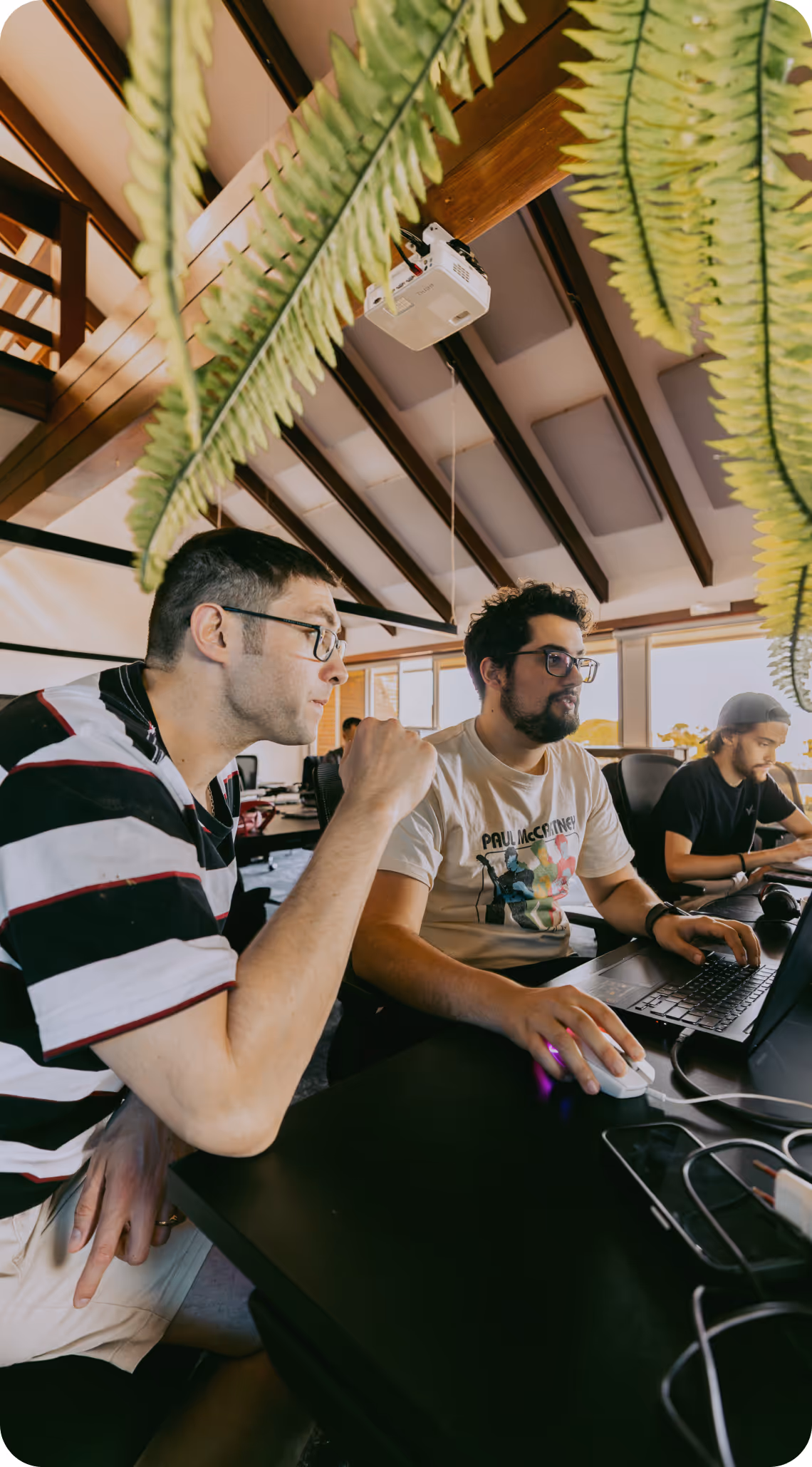 Kaizen Softworks developers collaborating in our modern office space. This image captures our hands-on, team-oriented culture and the focused environment where we build great software.