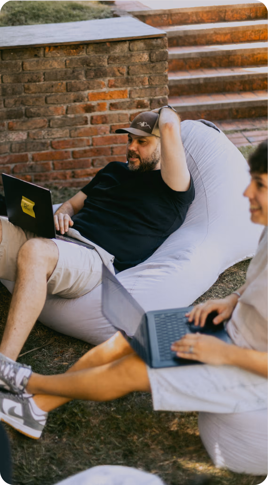 Two Kaizen Softworks team members collaborating in a relaxed outdoor setting. This image reflects our company culture of flexibility, trust, and a healthy work-life balance.