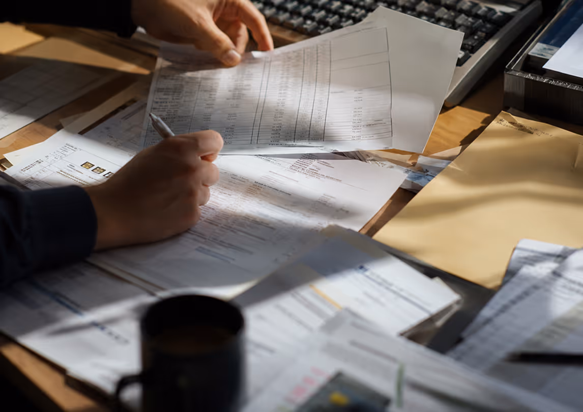 Paper-based logistics documents showing manual work used to bridge gaps between disconnected legacy systems.