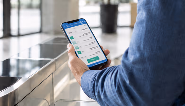Manager using a mobile app to monitor workplace health screening activity and safety status by location.