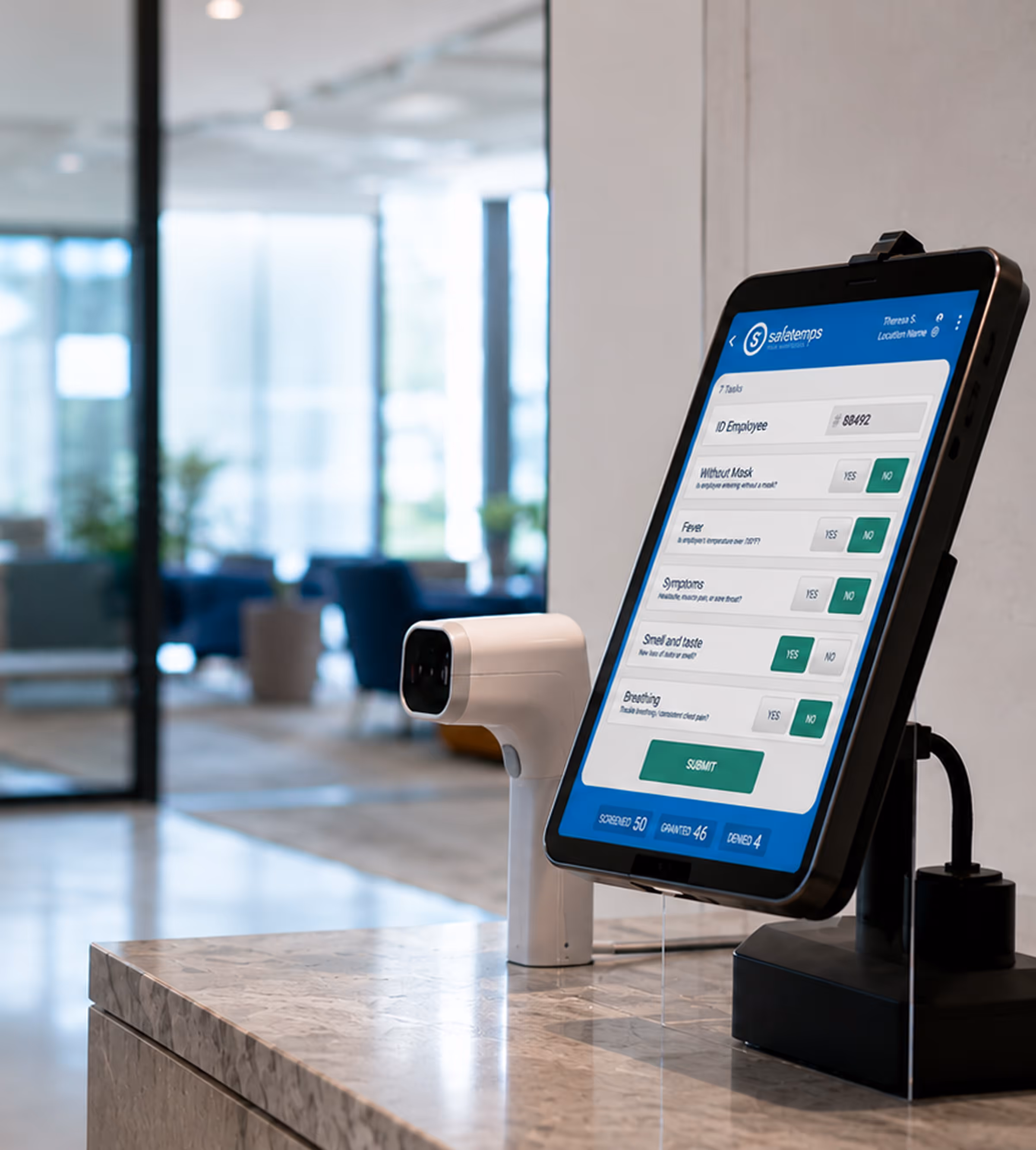 Digital health screening kiosk with touchless thermometer for automated workplace safety checks during COVID-19.