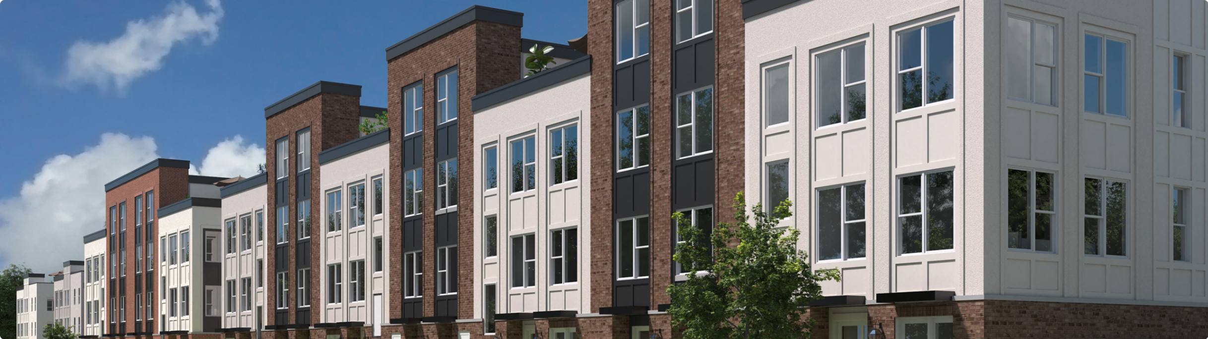 Street view of modern townhomes with brick and panel exteriors under a blue sky
