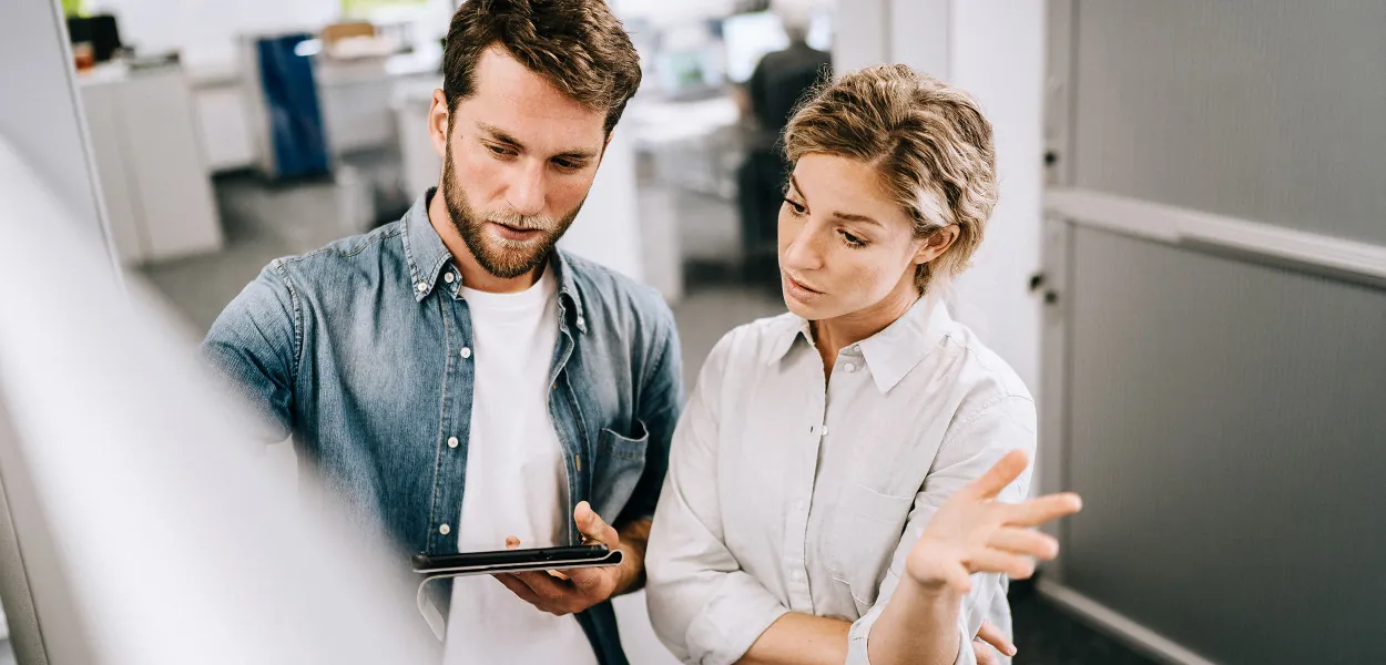 Two colleagues going through a plan together