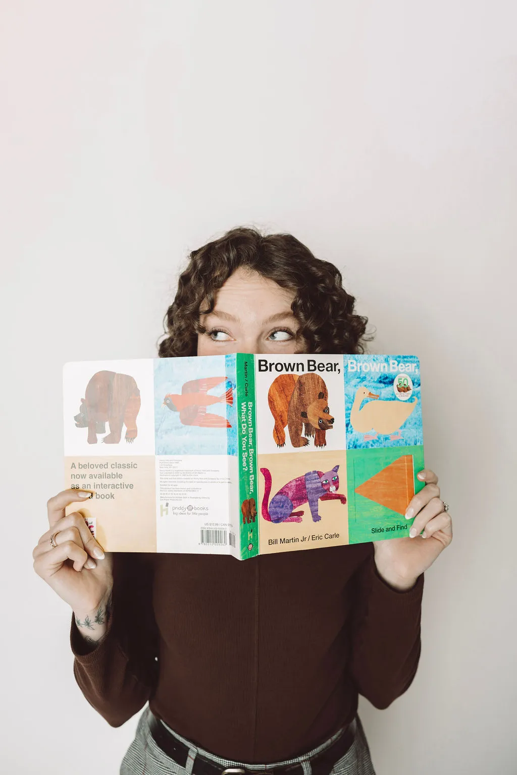 Tori holding up the book "Brown Bear, Brown Bear, What Do You See?" by Bill Martin Jr.