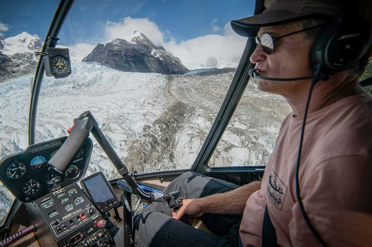 Scenic helicopter flight over turquoise Patagonian lakes, arriving at The Bertrand Stay Chile