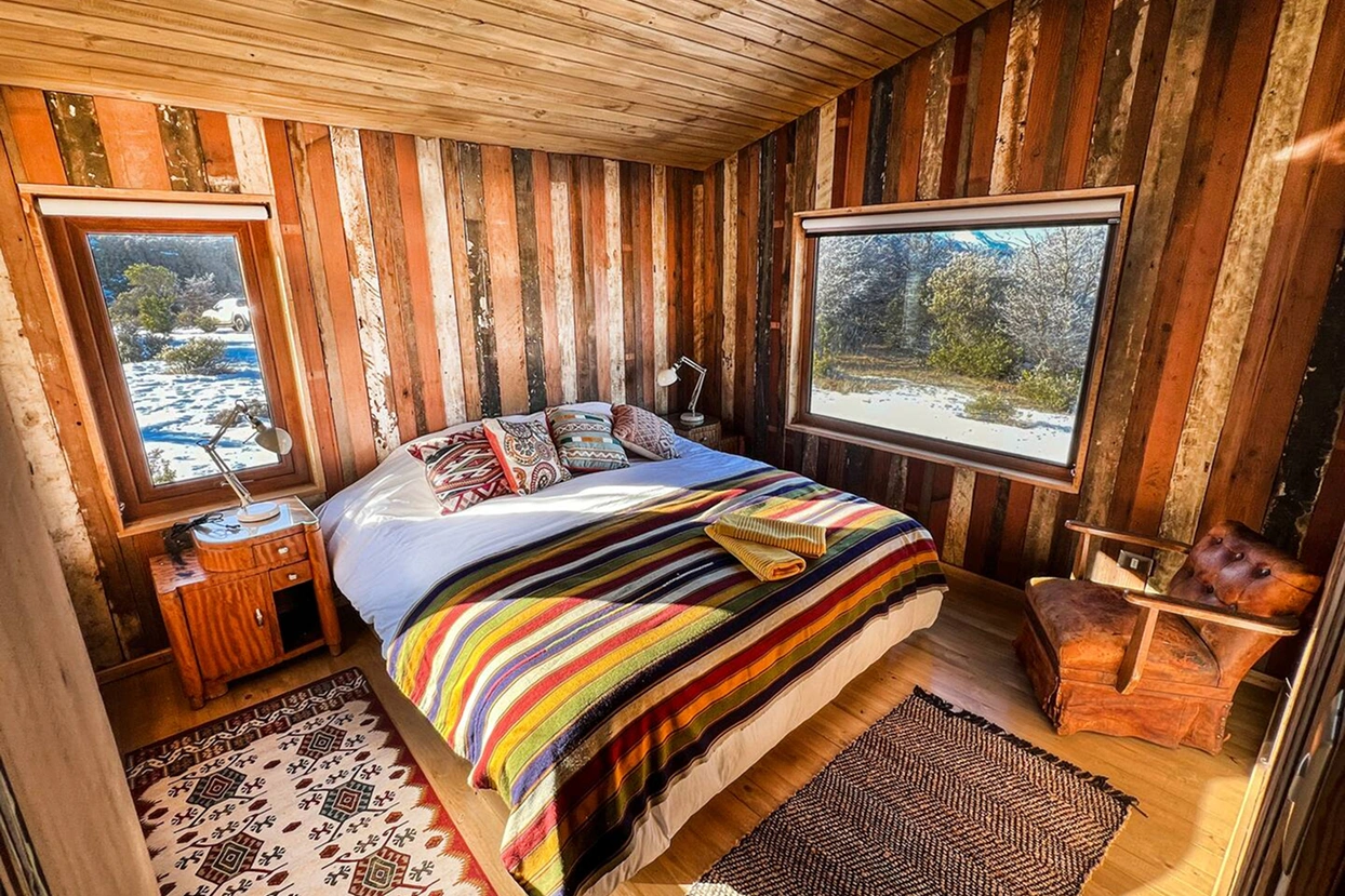 Spacious living area with Cerro Castillo views at Beyond the Castillo private lodge, Chile