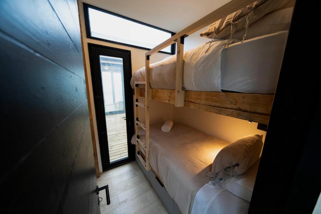 Warm Lenga wood bedroom interior at Bahia Murta House, private Carretera Austral accommodation