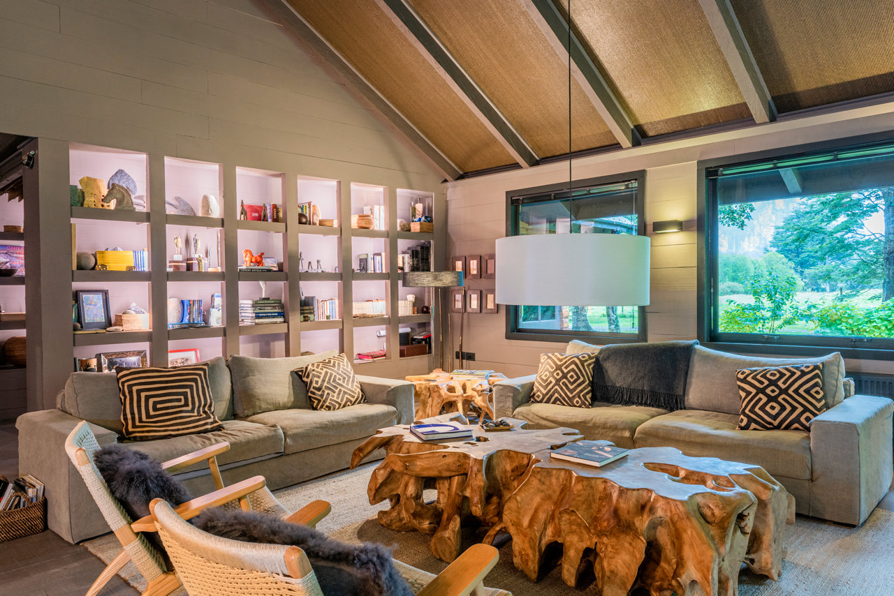 Lodge living room with forest views at a Patagonia lodge near Coyhaique