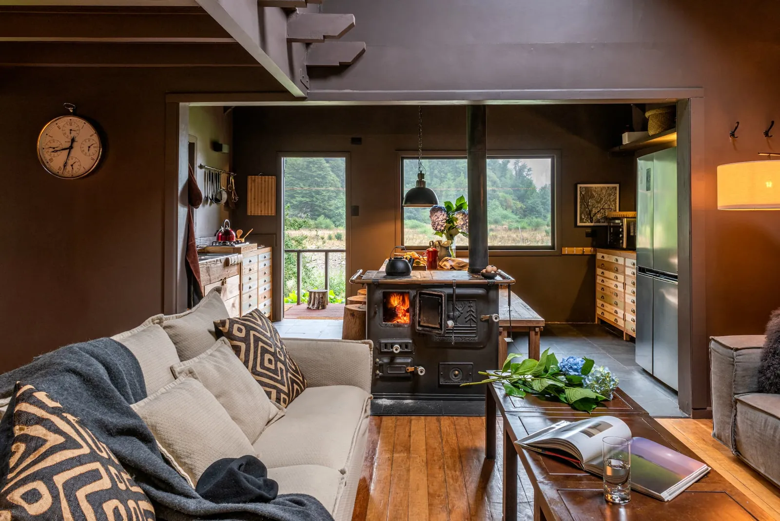 Cottage living room and kitchen with a wood-burning stove, cabin on the Carretera Austral