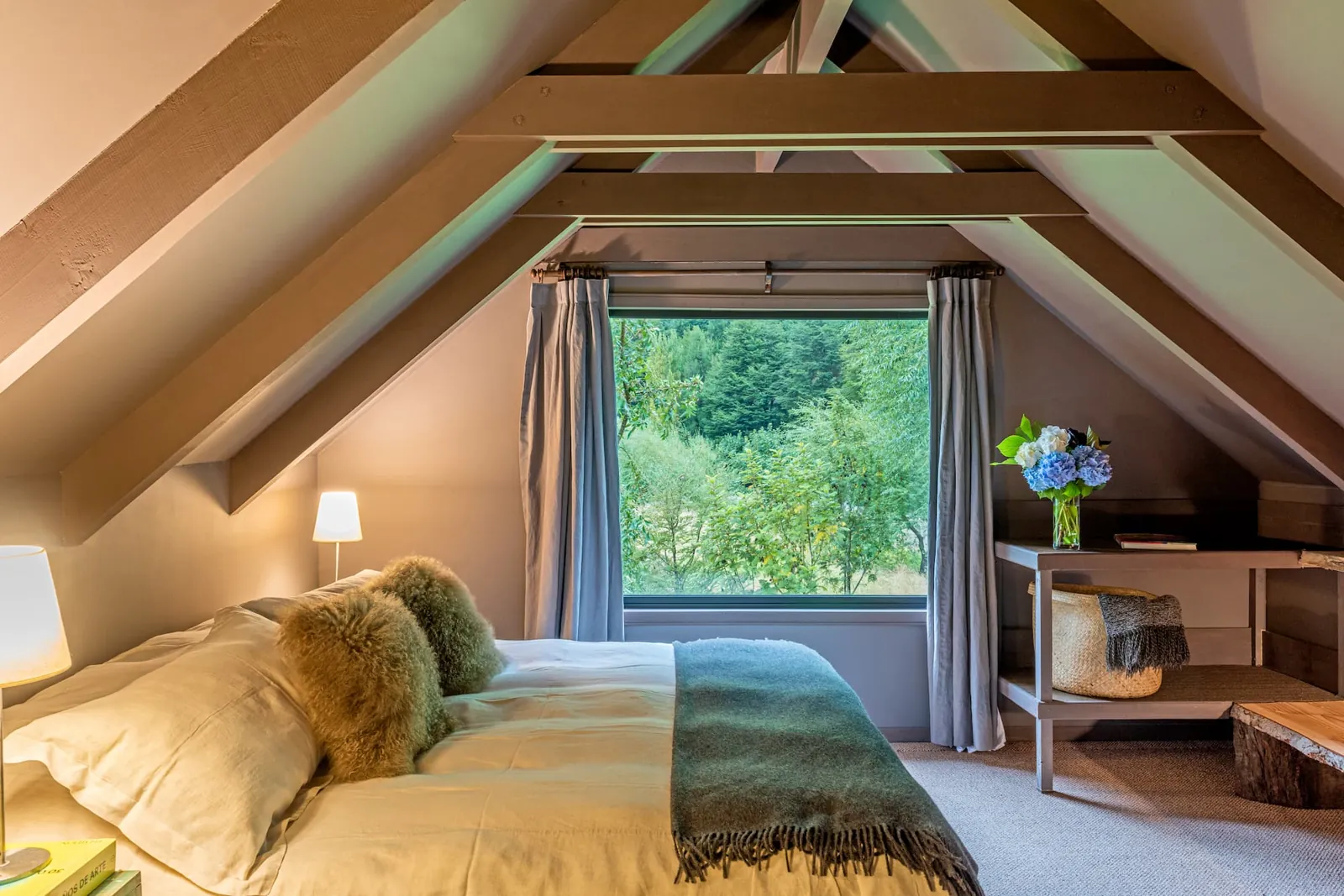 Cottage king suite under wooden beams with forest views, Patagonia accommodation near Coyhaique