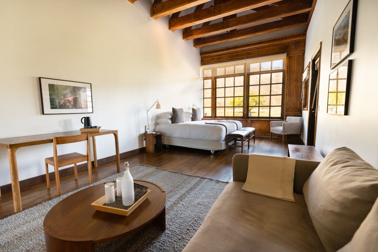 Suite with sitting area and valley views at Explora Patagonia National Park lodge