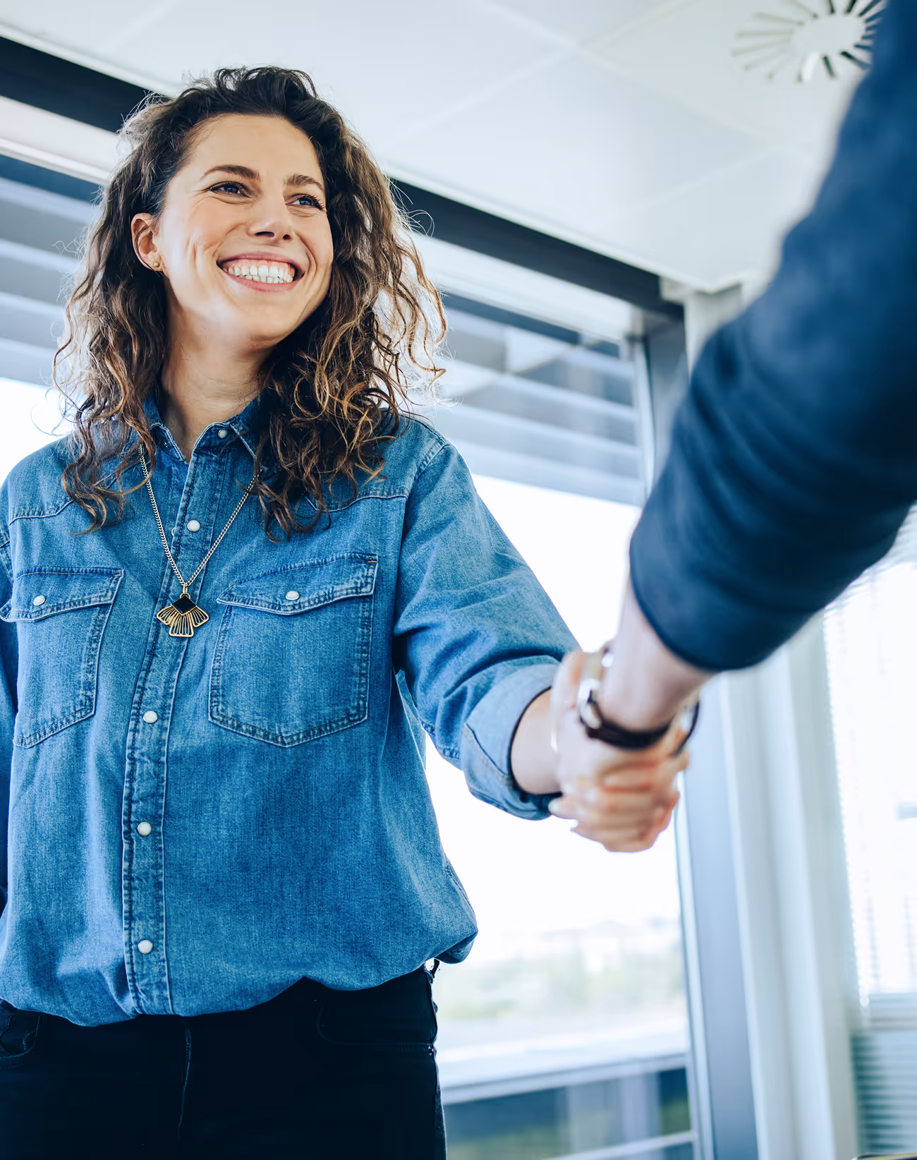 woman shaking hands with employer