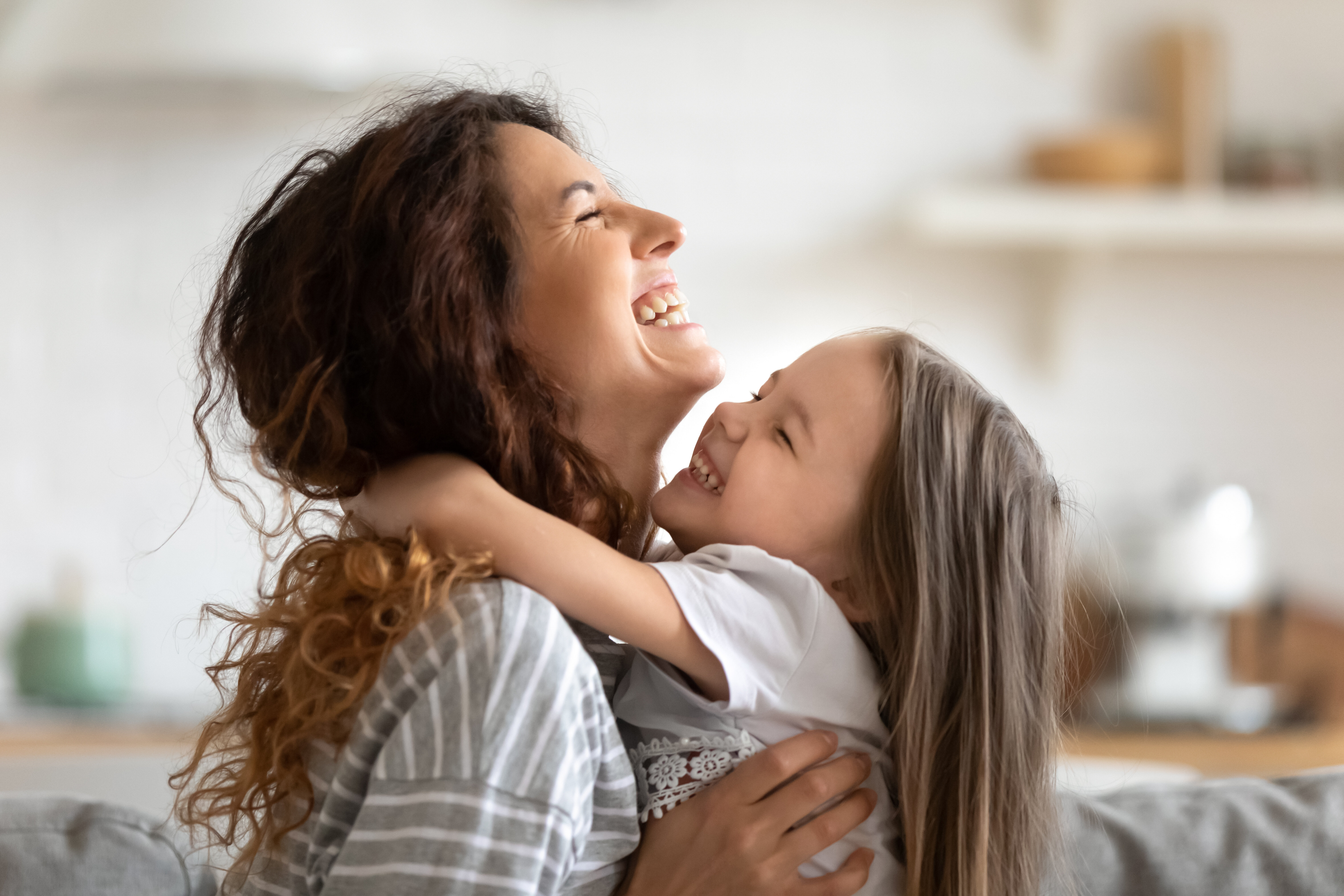 woman holding child laughing stock image