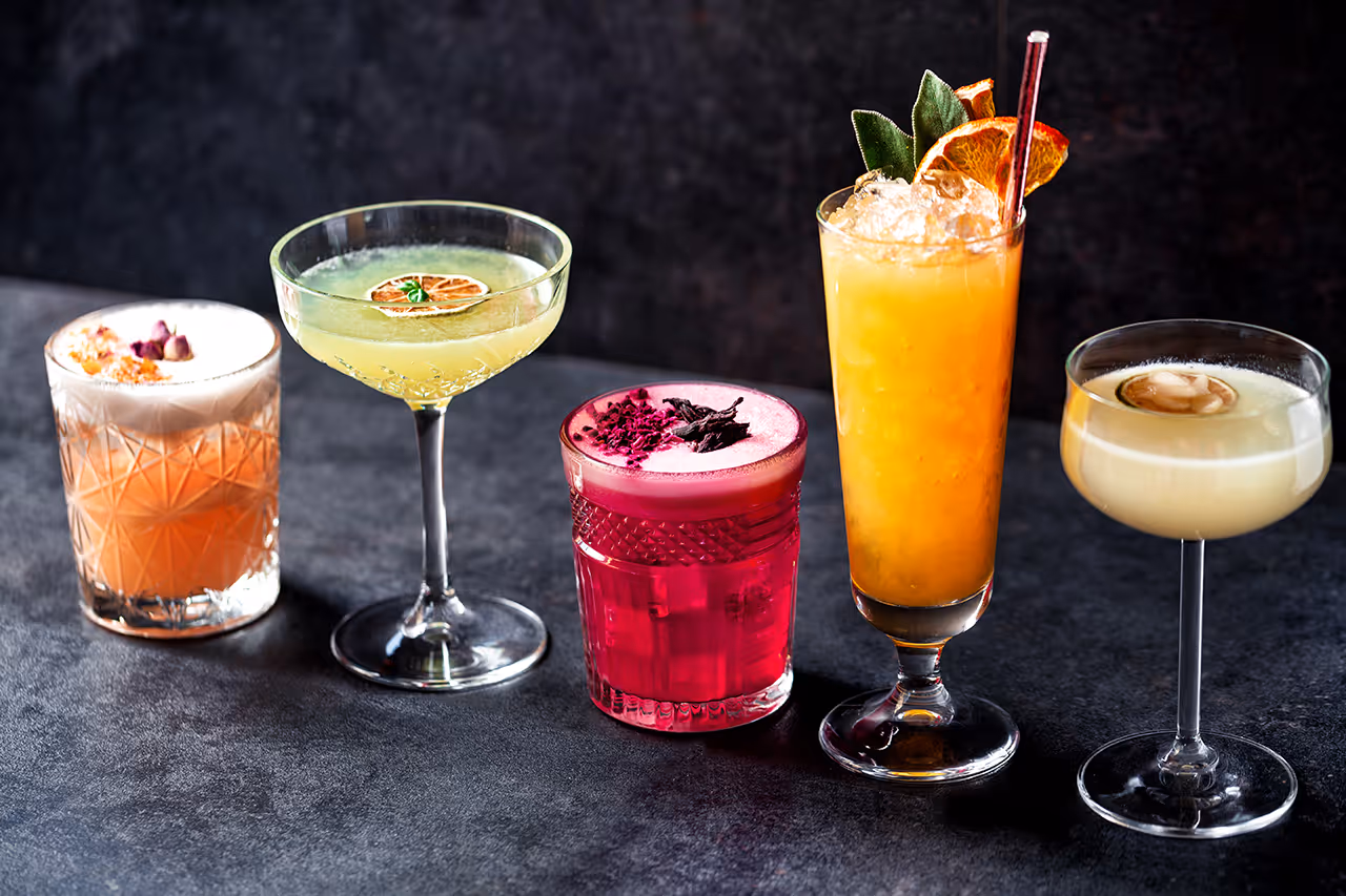 A table with a variety of drinks on it.