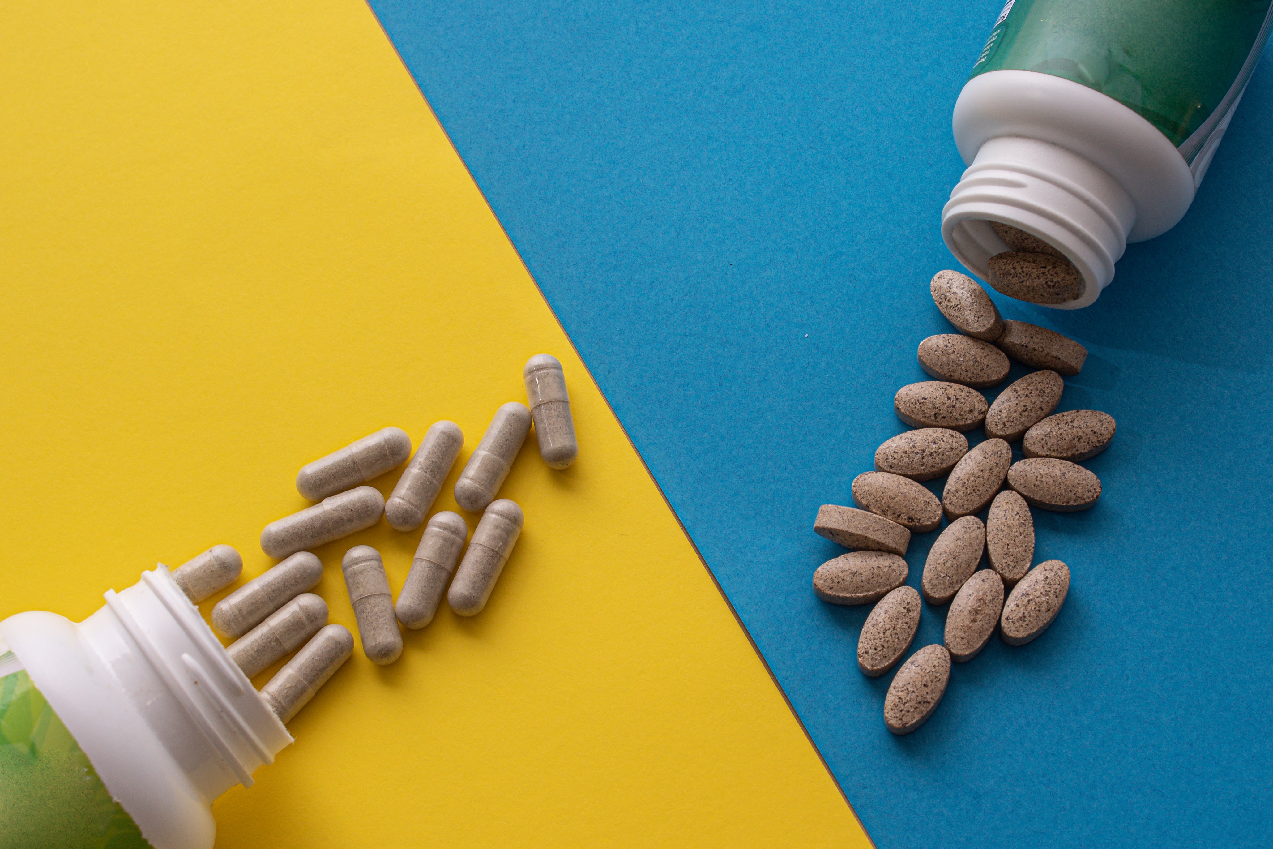 overhead-shot-of-containers-of-pills-on-a-blue