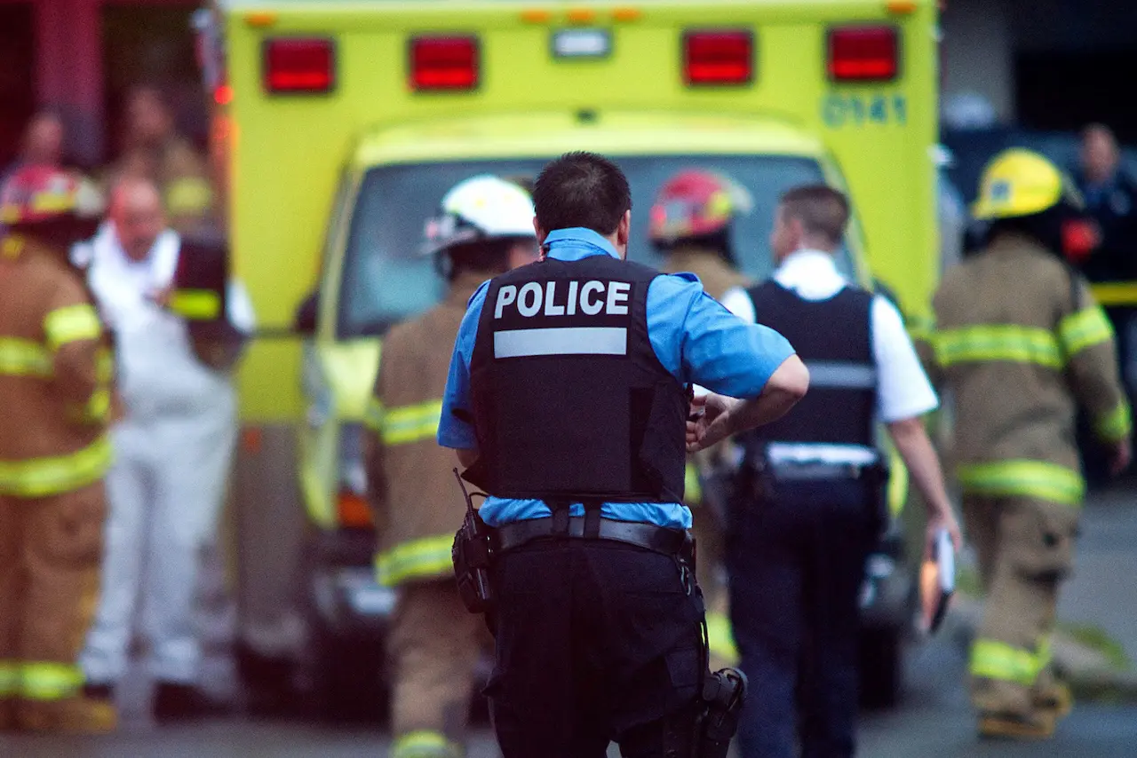 A police officer at hectic public safety interoperability mutual aid scene.