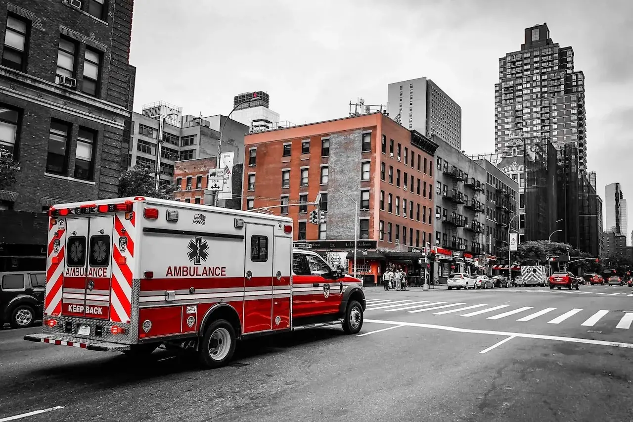An ambulance drives through a city.