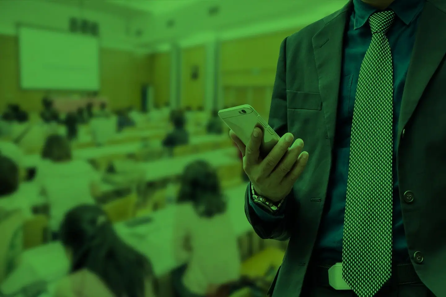 A teacher views an alert from Tango Tango while standing in a classroom