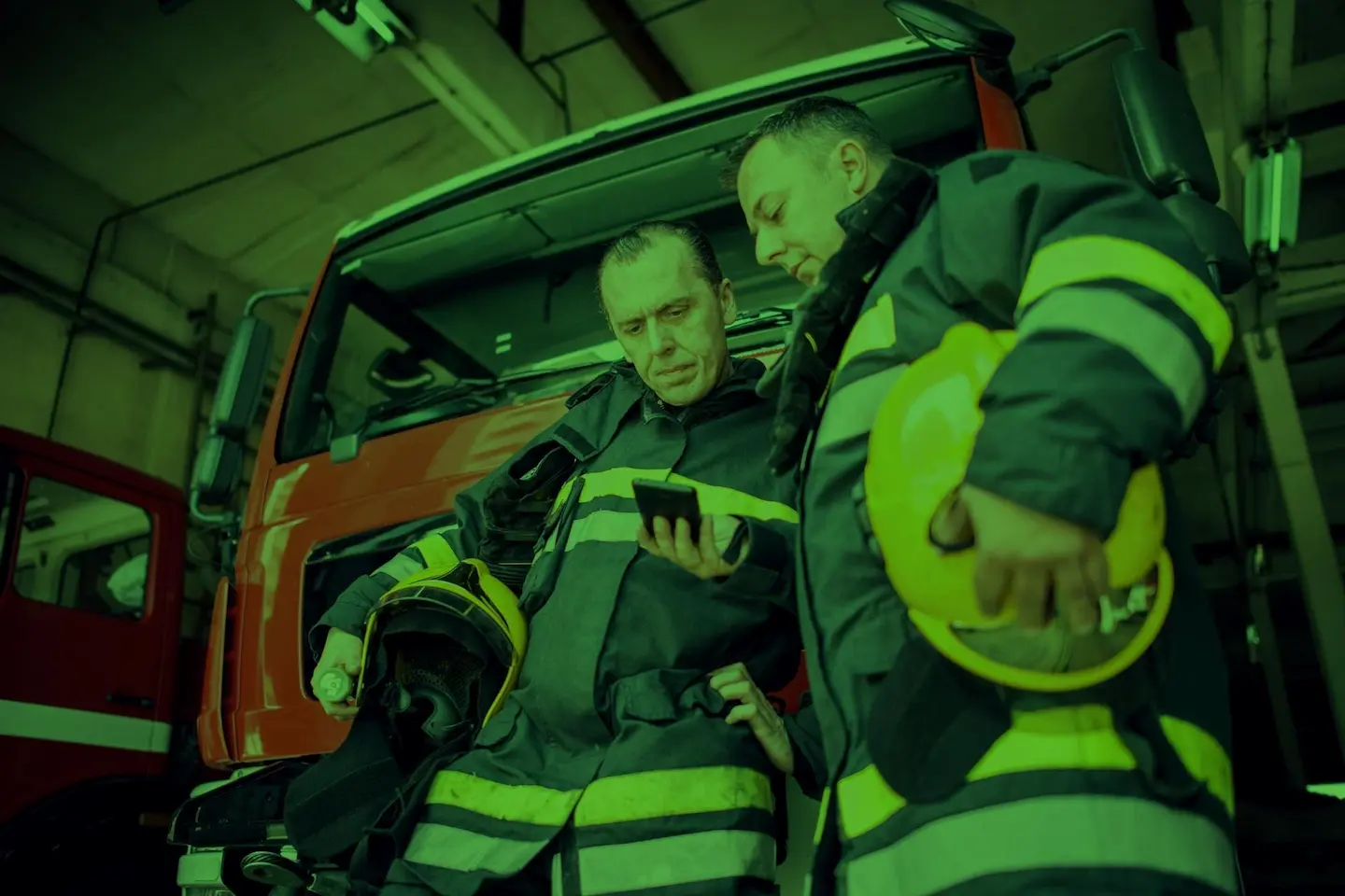 Two firefighters review a CAD Alert.