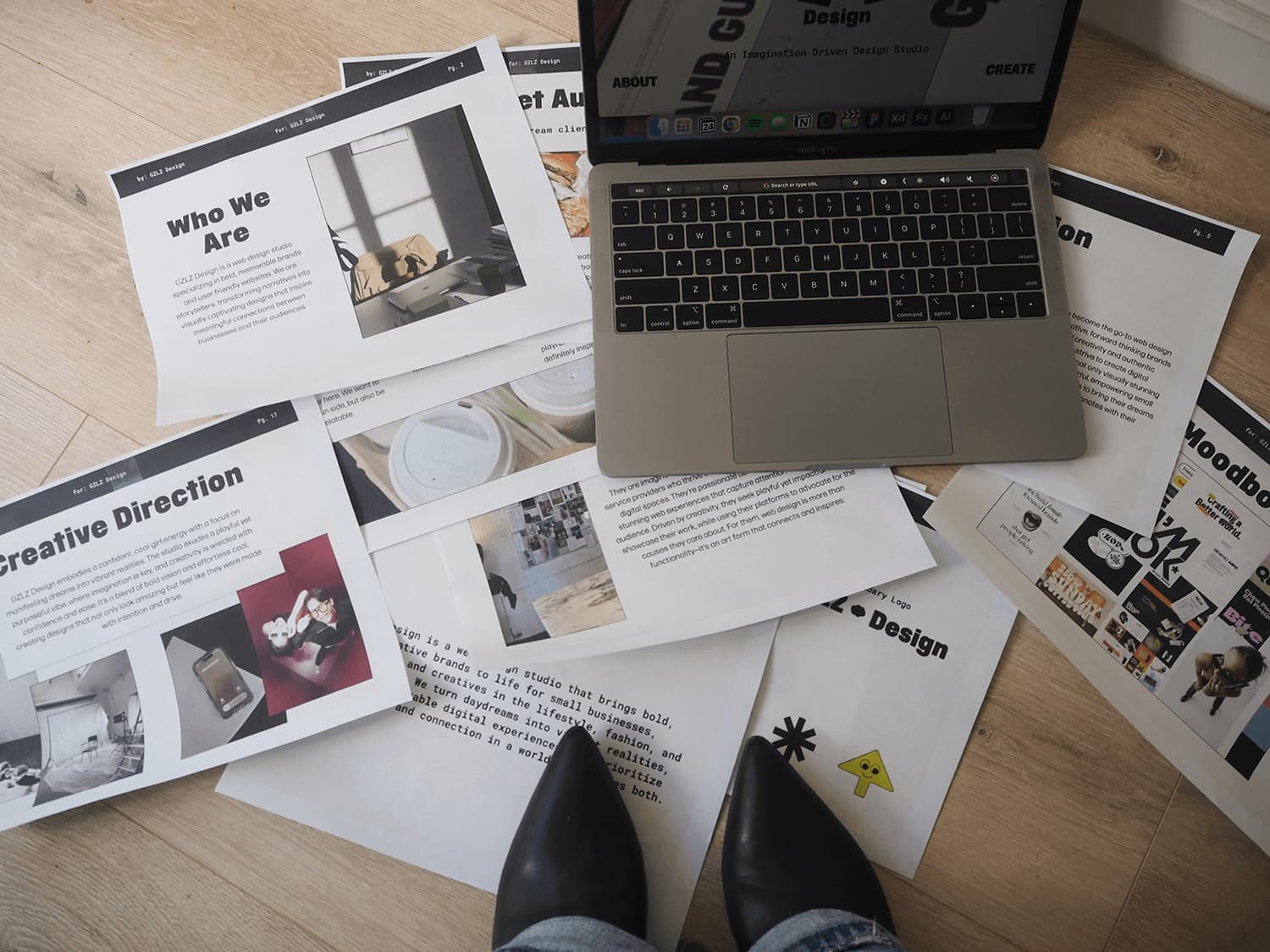brand guidelines papers on floor with laptop on top