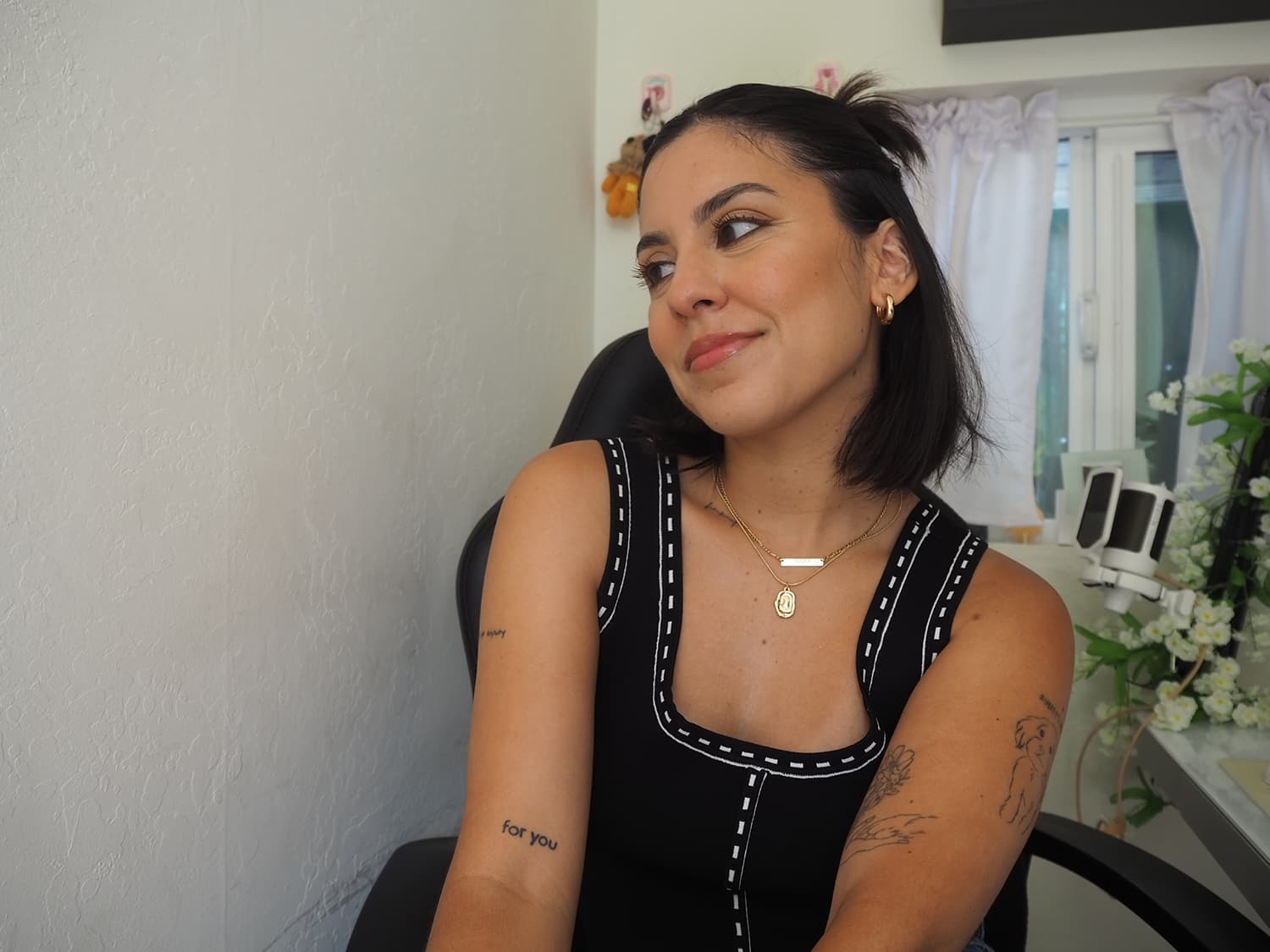 Image of Mayra sitting on chair looking away
