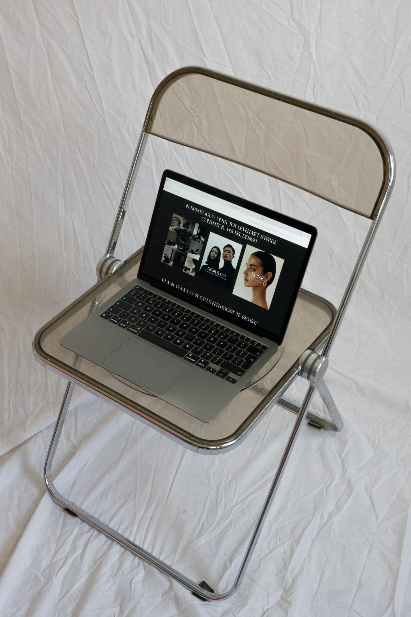 laptop on a chair showcasing a website