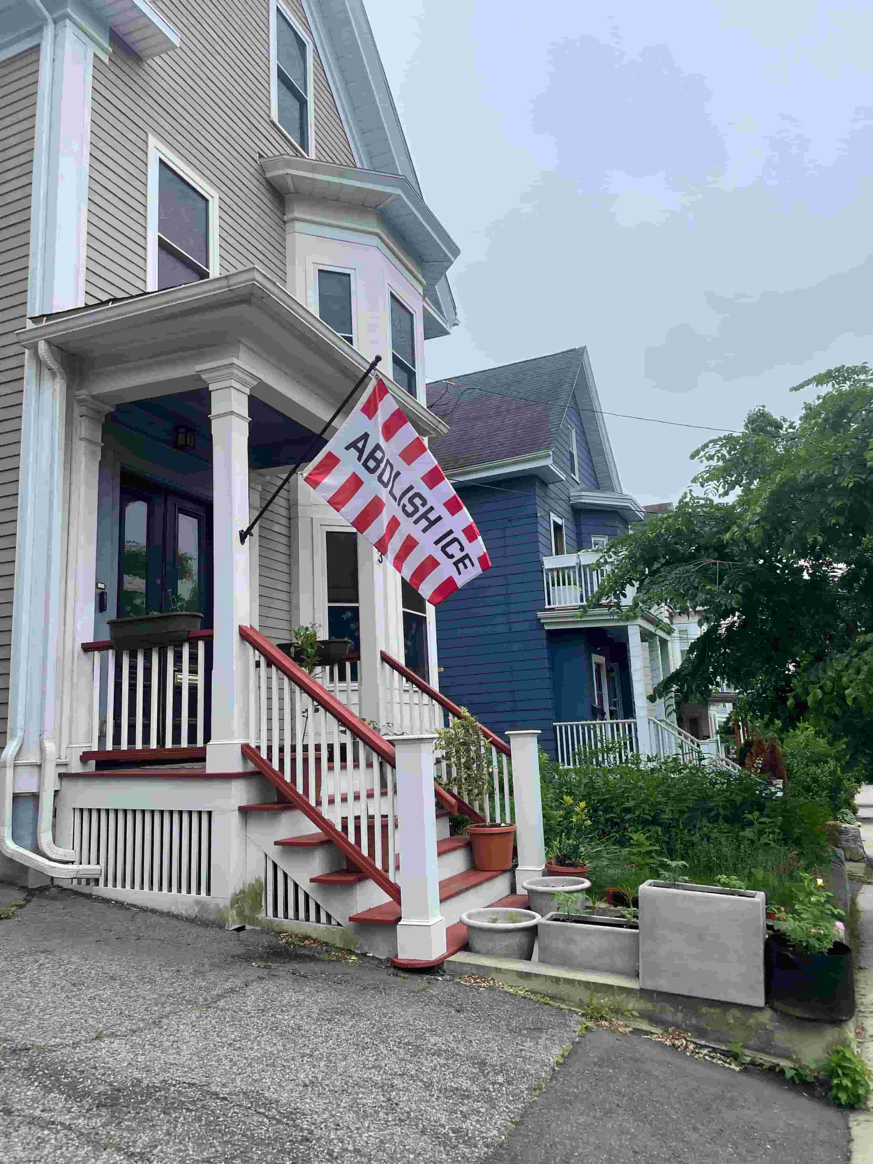Flag on house that reads "Abolish Ice"