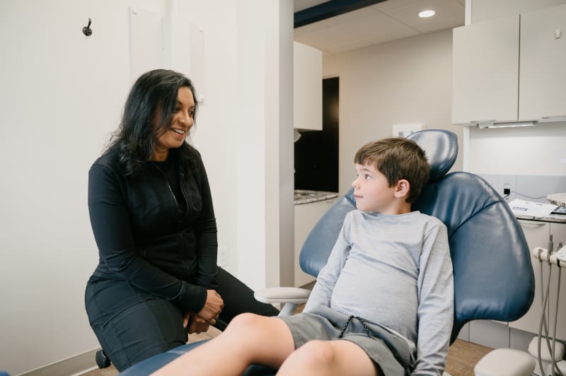 Female dentist counseling patient in comfortable consultation setting