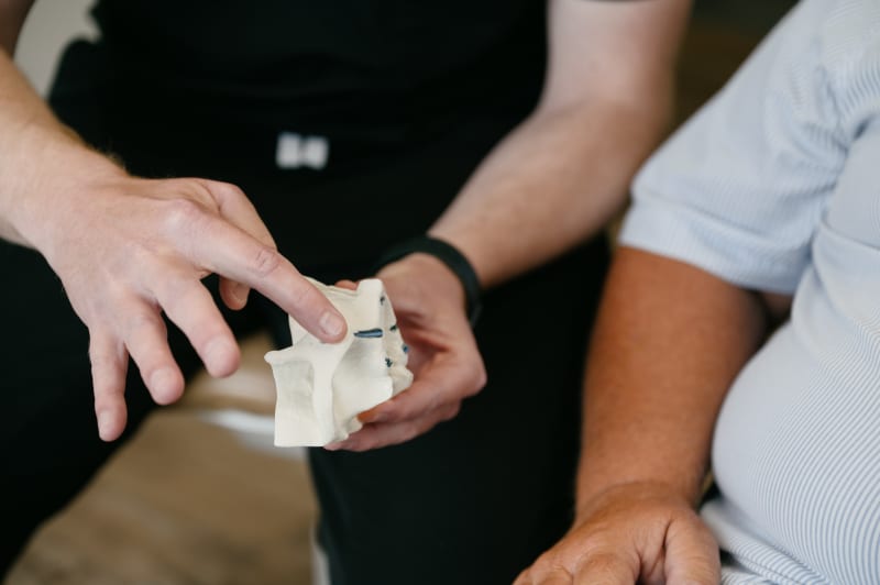Dentist and patient examining dental implant models together