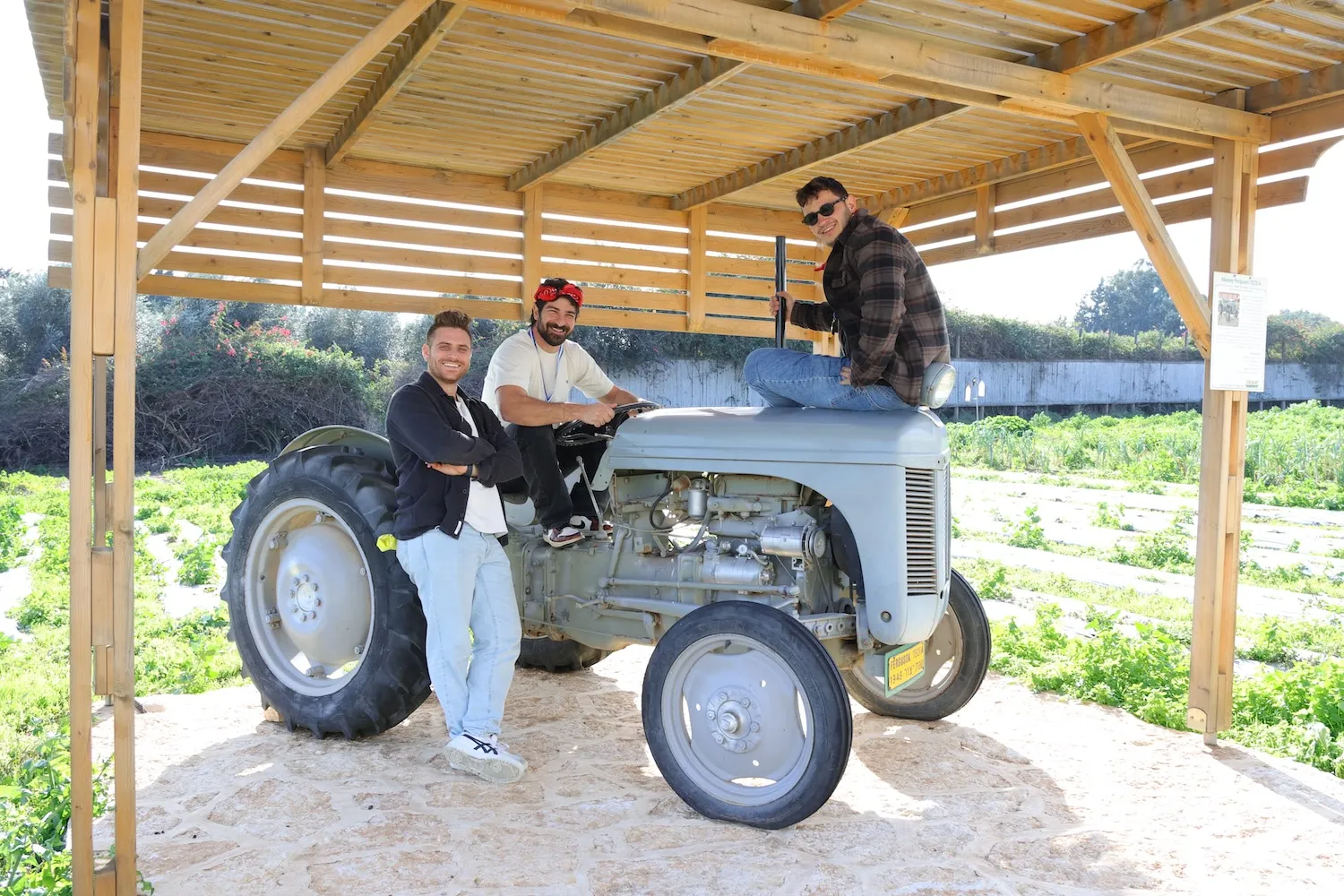 A couple of men sitting on top of a tractor.