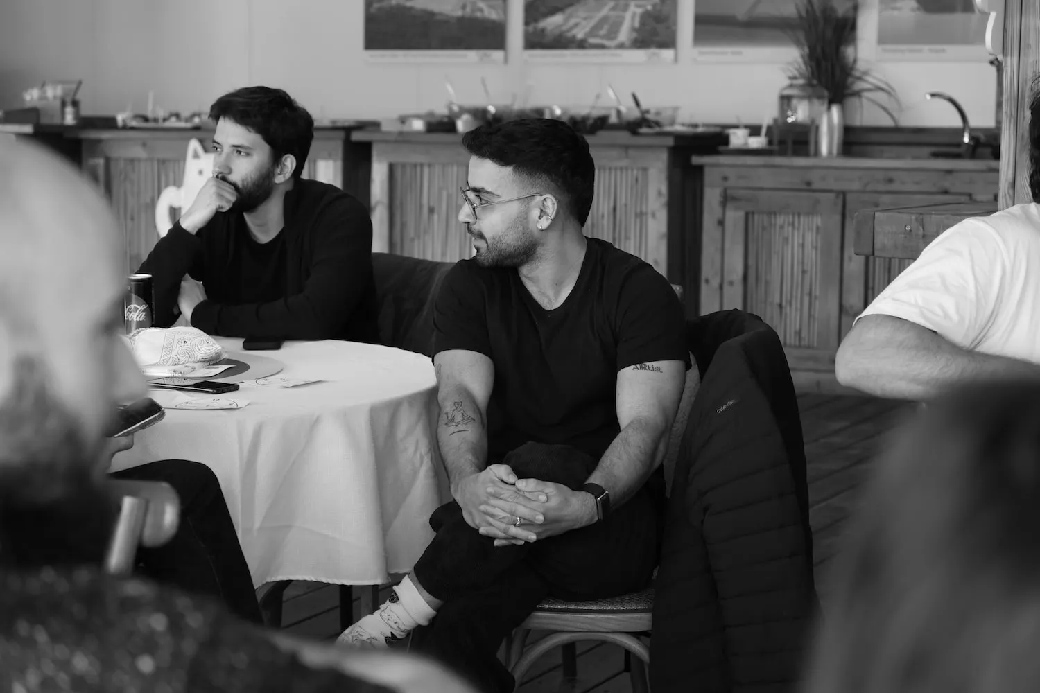 A group of men sitting around a table.