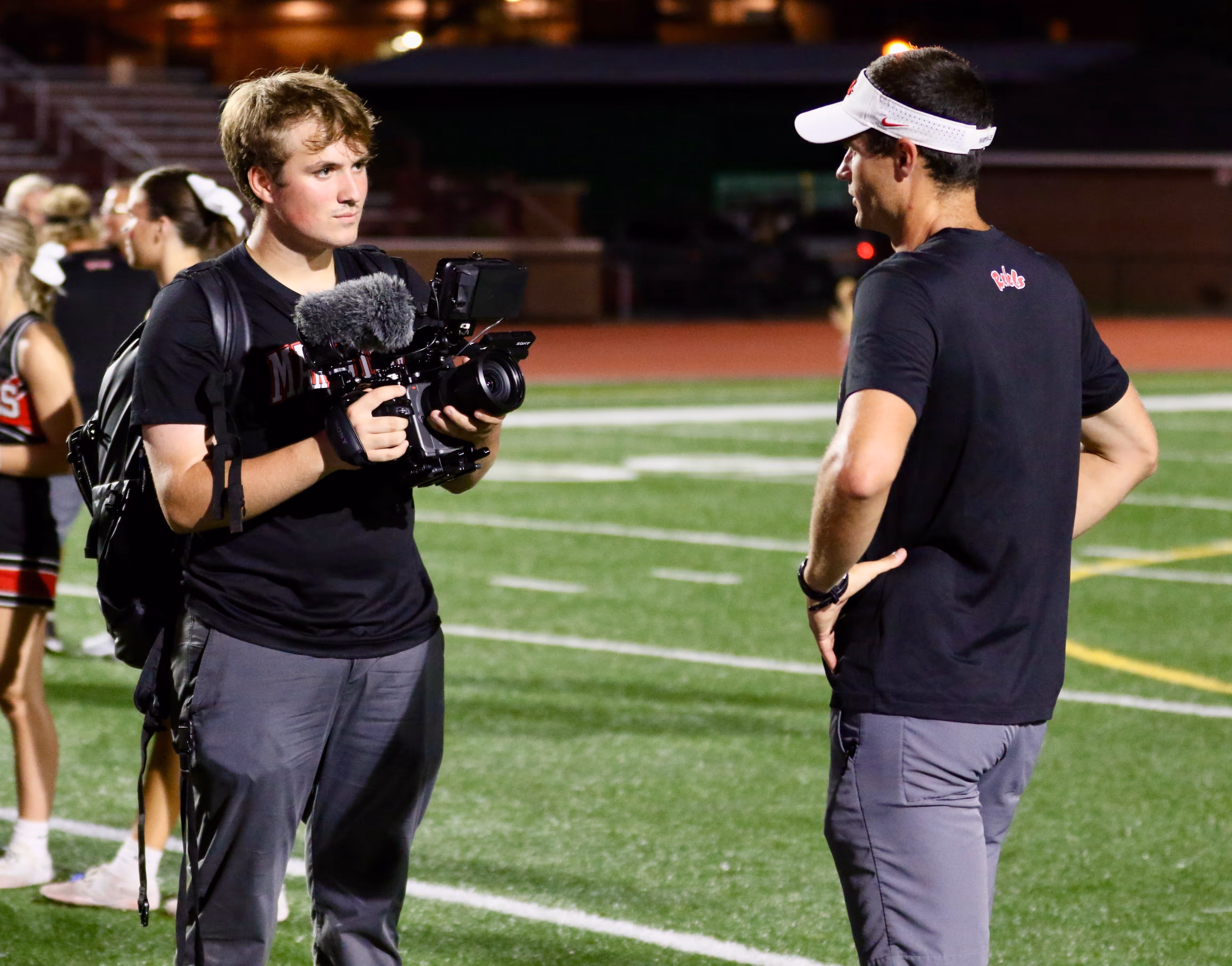 CJ Newton, founder of Newton Creative, filming an interview with Maryville High School Football Head Coach, Derek Hunt. 