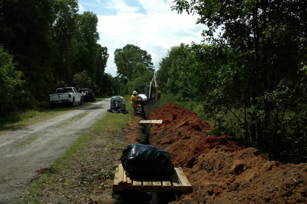 BASS technicians performing cathodic protection maintenance on pipeline infrastructure in the field