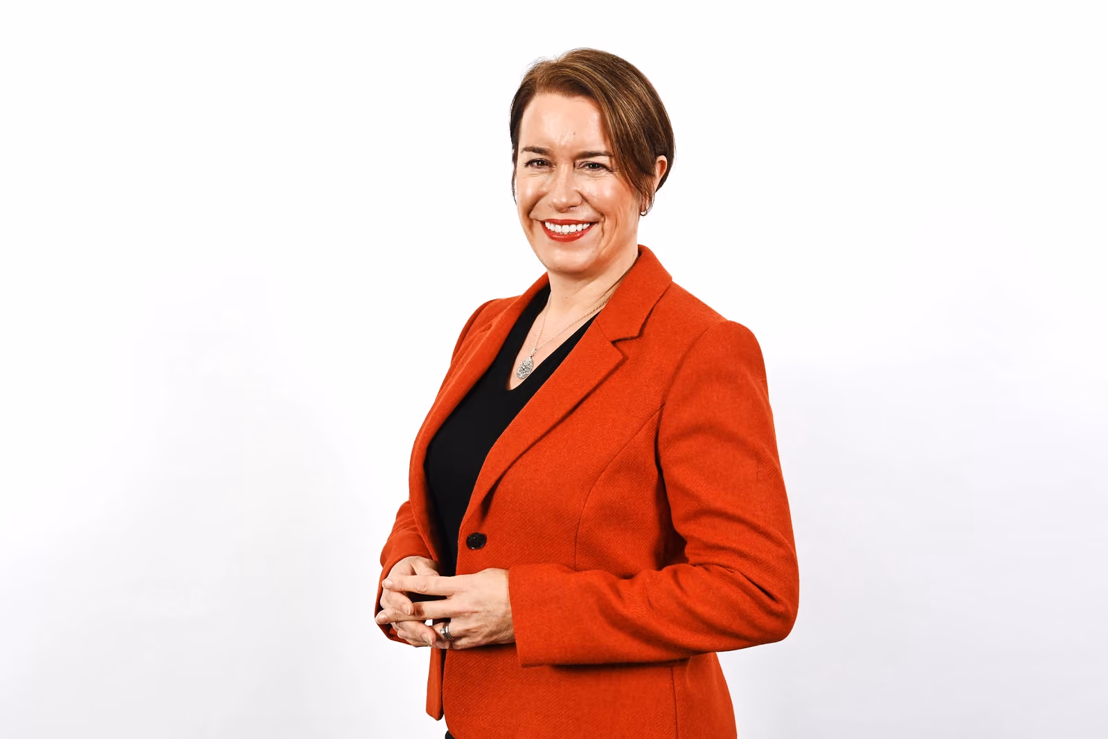 Sally Lawson in a red suit smiling at camera