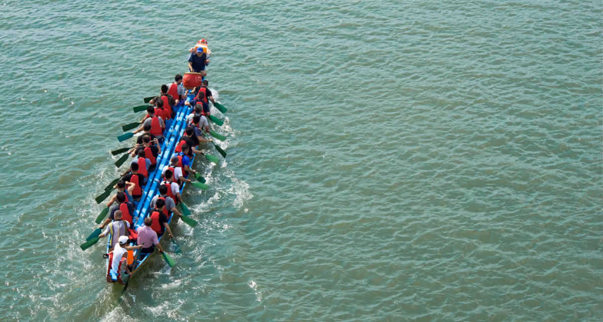 A top-down picture of a dragon boat being rowed