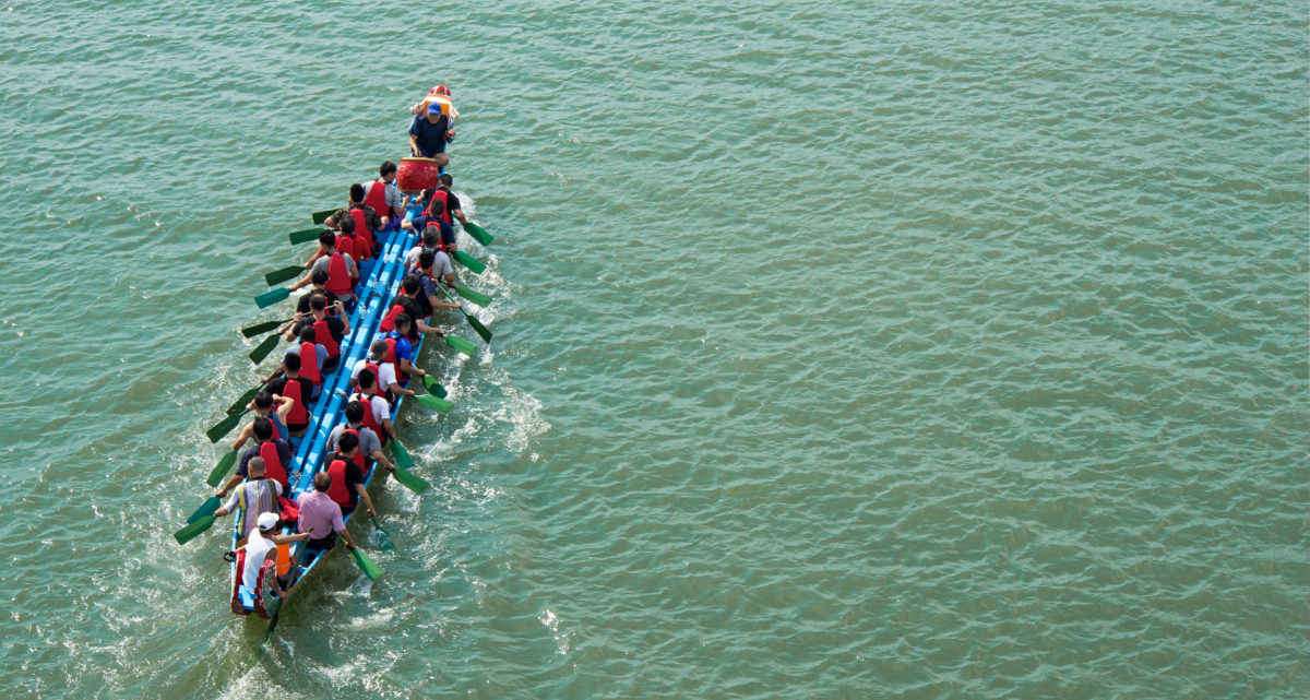 A top-down picture of a dragon boat being rowed