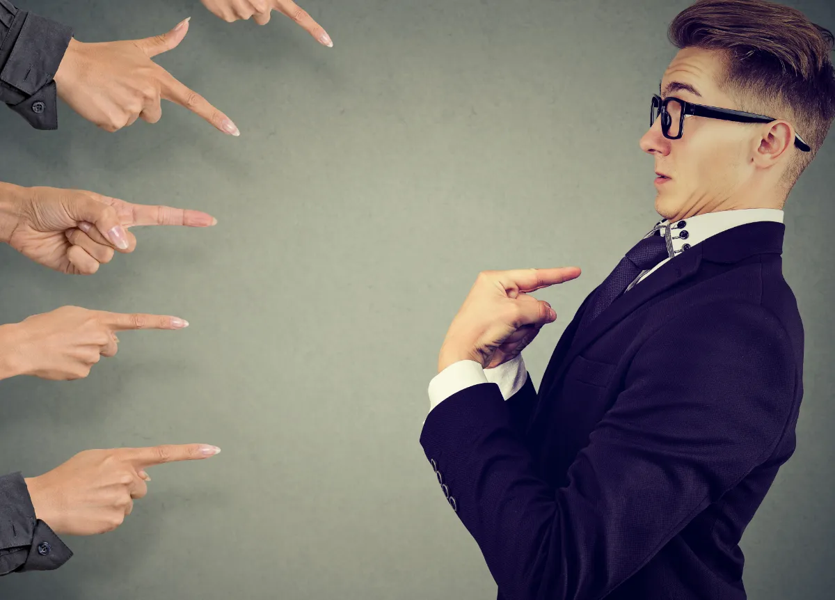 Businessman judged by different people pointing fingers at him