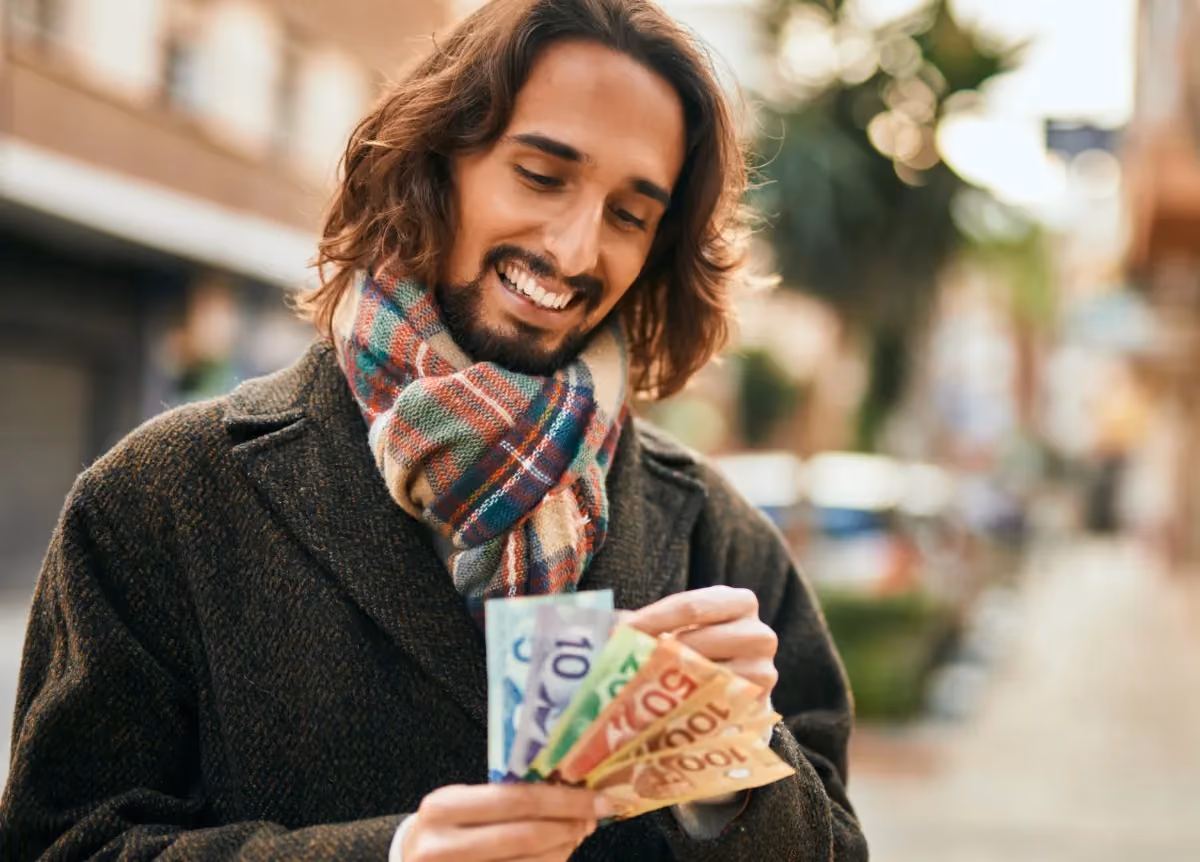 Man counting Canadian money