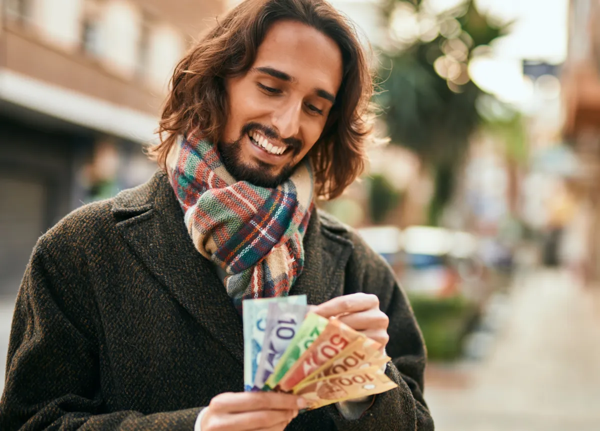 Man counting Canadian money