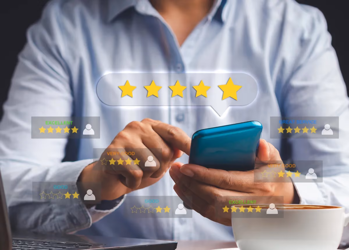 A man tapping a smartphone screen surrounded by 5-star review icons