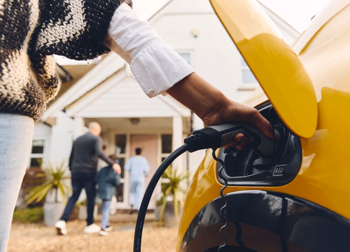 Woman charging her electric vehicle