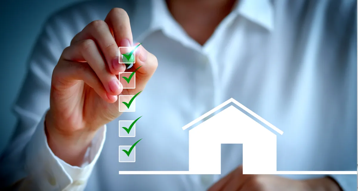 A person ticking a box next to a flat image of a house
