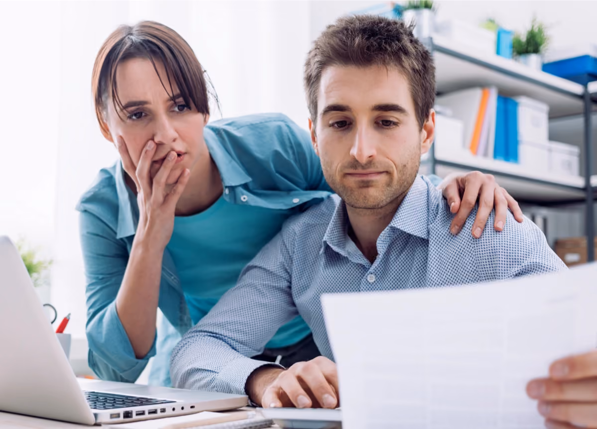 Young couple surprised and stressed by a bill