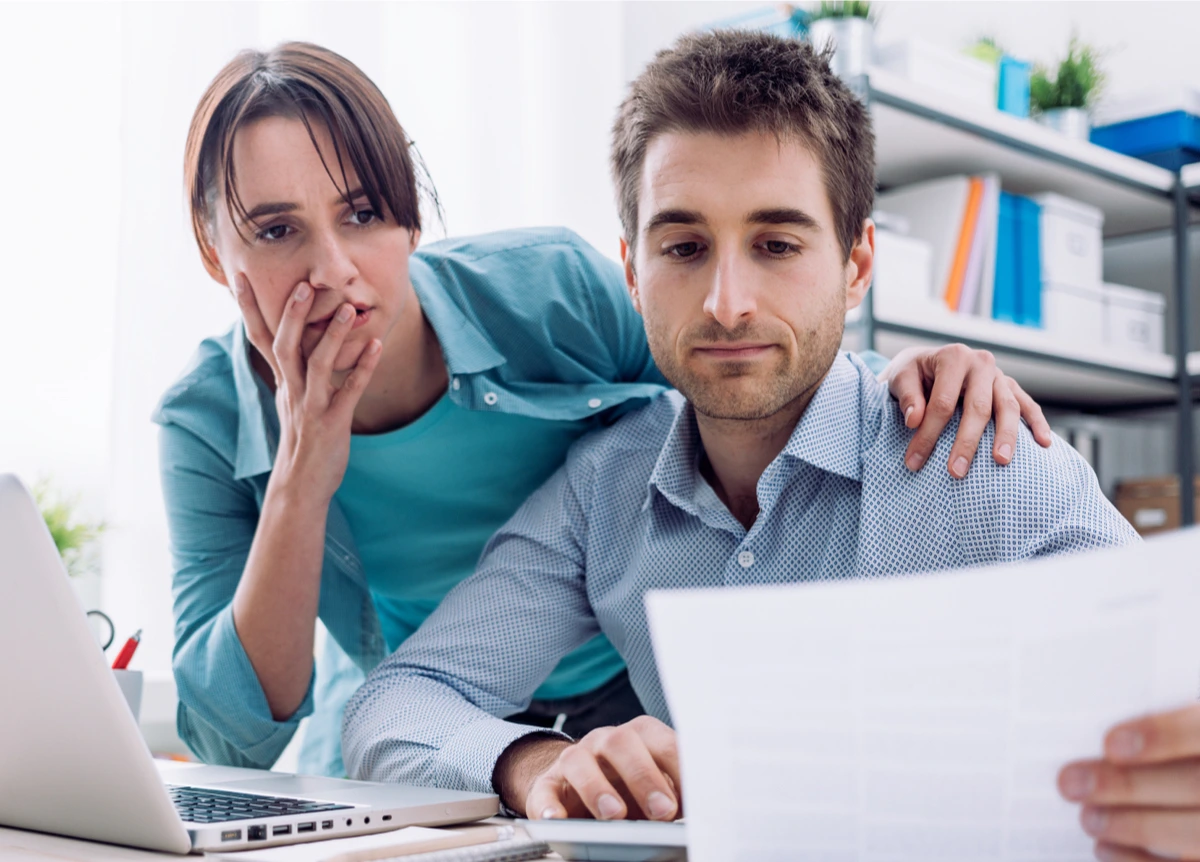 Young couple surprised and stressed by a bill
