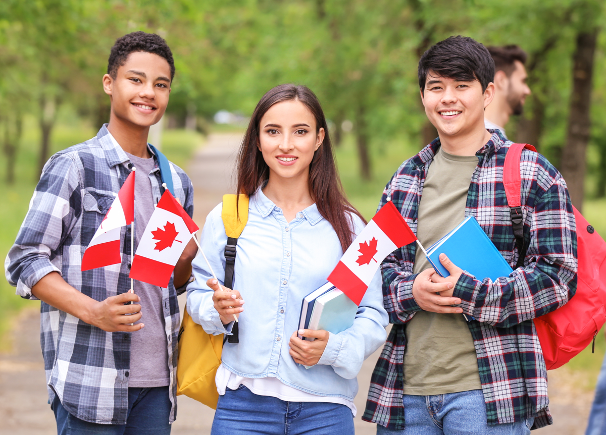 Group of students holding Canadian flags